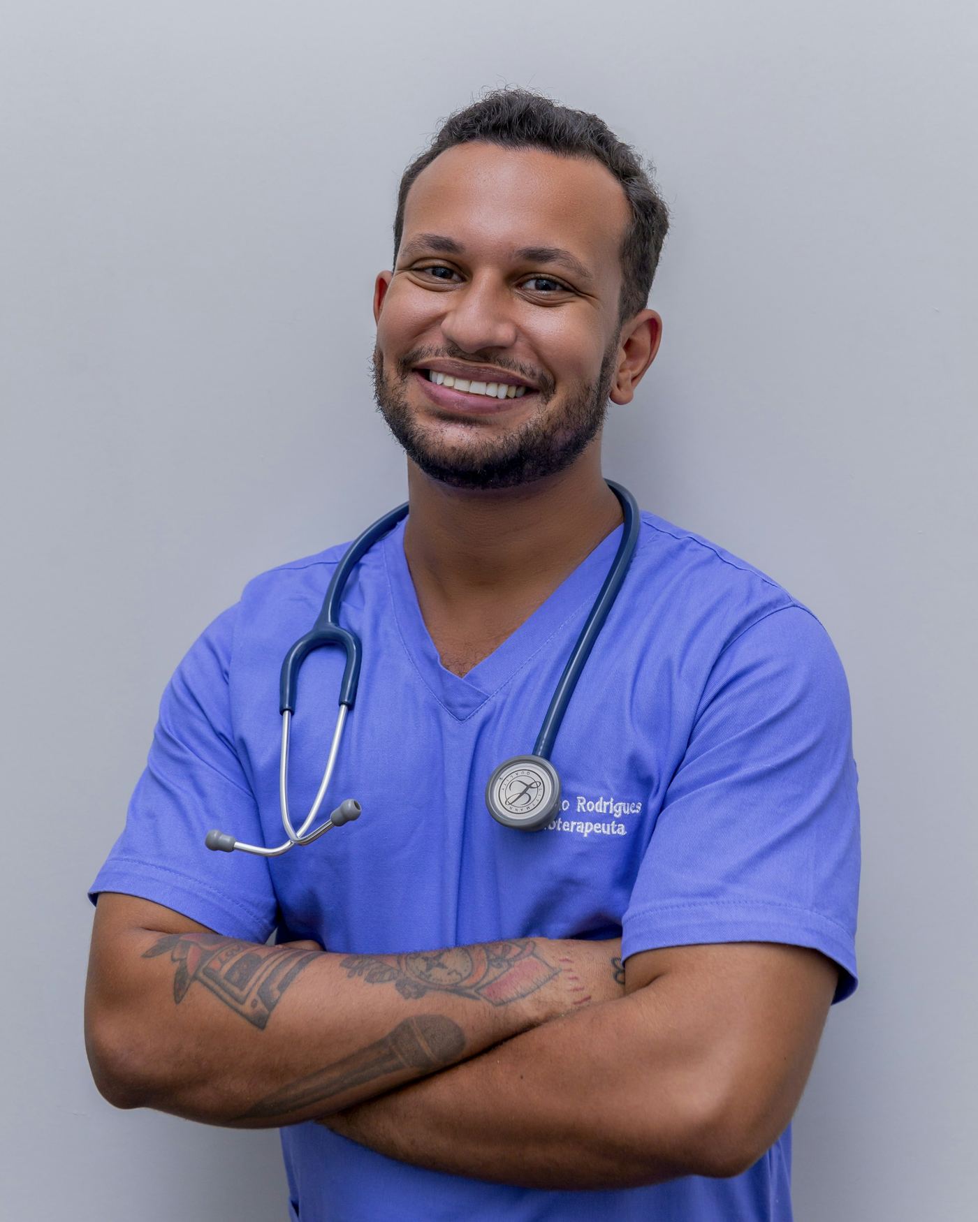 Stock portrait of a man in a blue medical uniform, standing in for the therapist in this demo